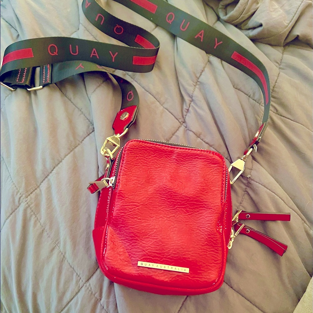 Quay red patent cross body camera bag OR belt bag.